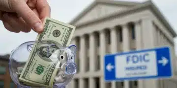 Hand placing money into a piggy bank with FDIC insurance sign in background